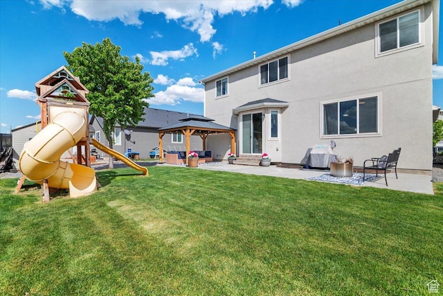 rear view of house with an outdoor hangout area, a patio area, a yard, and a gazebo