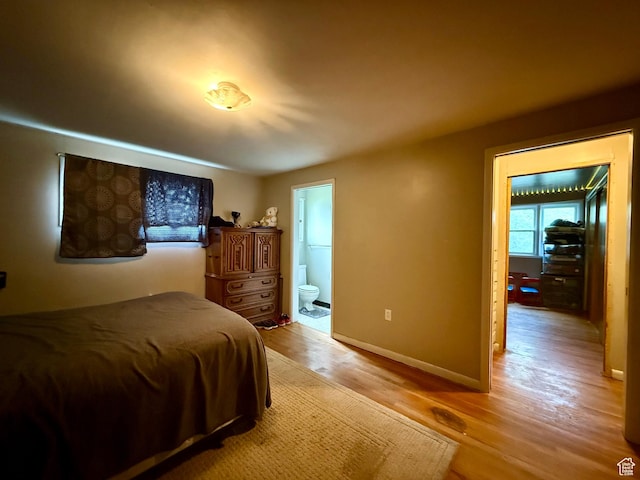 479 S Vernal Ave, Vernal, UT 84078 - bedroom with light wood-type flooring, ensuite bathroom, and baseboards