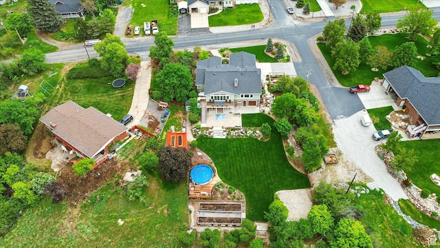 aerial view of property and surrounding area featuring nearby suburban area