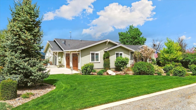 ranch-style home featuring a front yard and a patio area