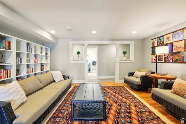 living room with wood finished floors, recessed lighting, and baseboards