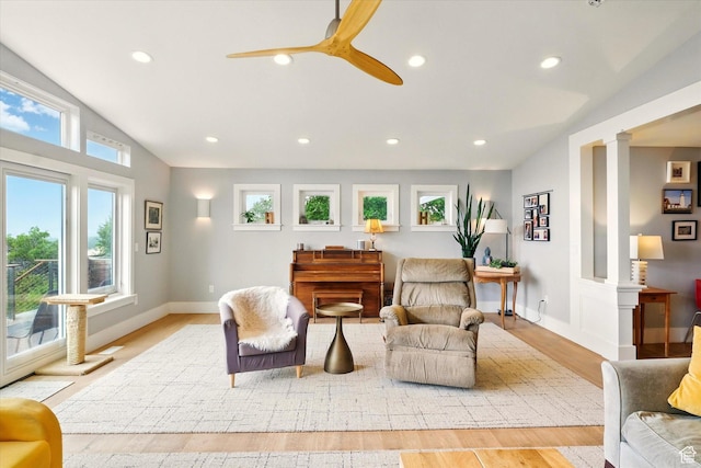 living area with lofted ceiling, light wood-style floors, recessed lighting, ceiling fan, and decorative columns