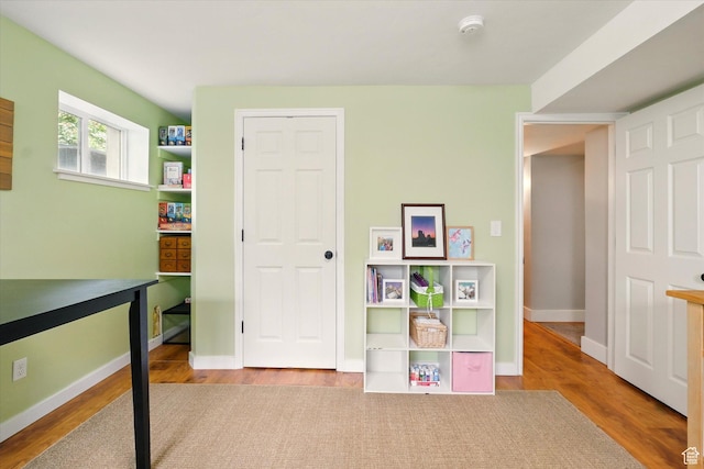 rec room featuring wood finished floors and baseboards
