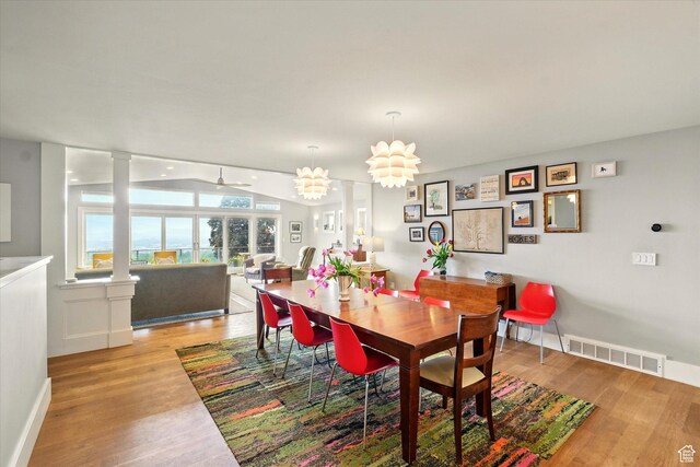 dining space featuring light wood-style floors, baseboards, and ceiling fan