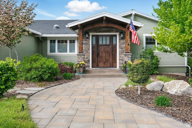 property entrance featuring stone siding