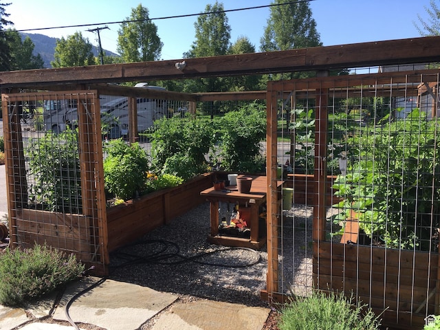 view of patio featuring a vegetable garden and a mountain view