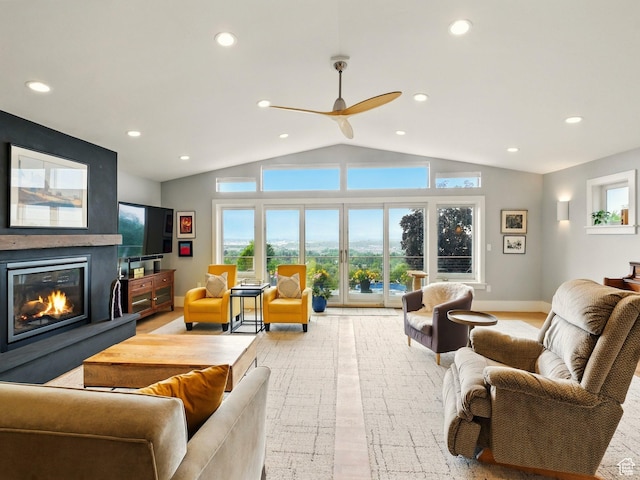 living area with lofted ceiling, a large fireplace, recessed lighting, ceiling fan, and baseboards