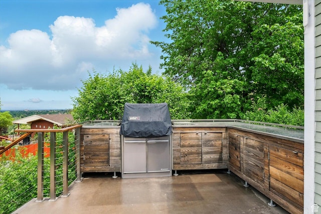 view of patio with an outdoor kitchen and a grill