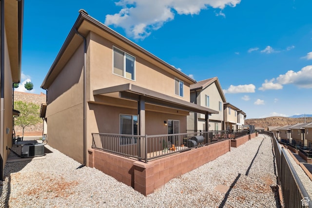 5849 S Firebird Way, St George, UT 84790 - rear view of house with stucco siding, central AC, a residential view, and fence