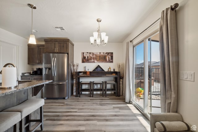 5849 S Firebird Way, St George, UT 84790 - kitchen featuring stainless steel fridge with ice dispenser, a sink, a chandelier, light wood-style floors, and dark brown cabinetry