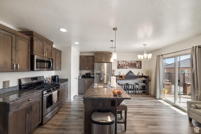 5849 S Firebird Way, St George, UT 84790 - kitchen featuring stainless steel appliances, a sink, dark wood-style flooring, a chandelier, and recessed lighting