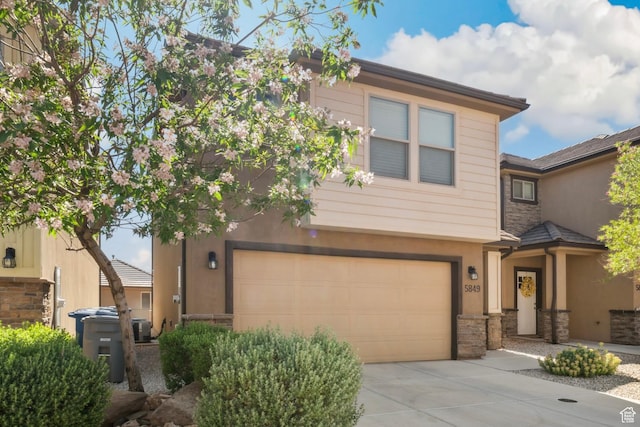 5849 S Firebird Way, St George, UT 84790 - view of front of home featuring a garage, stucco siding, concrete driveway, stone siding, and central AC unit