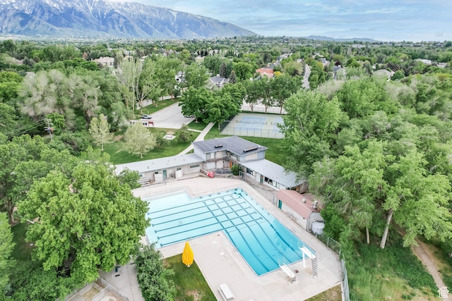 drone / aerial view of a mountain backdrop and a pool