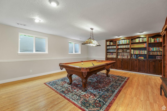 rec room featuring a textured ceiling, light wood-type flooring, pool table, and baseboards