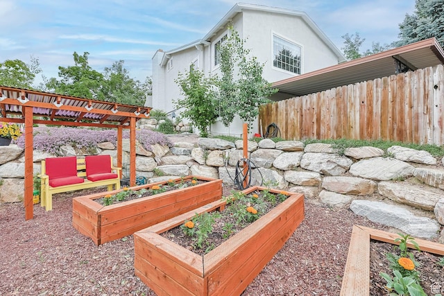 view of yard with a vegetable garden and fence