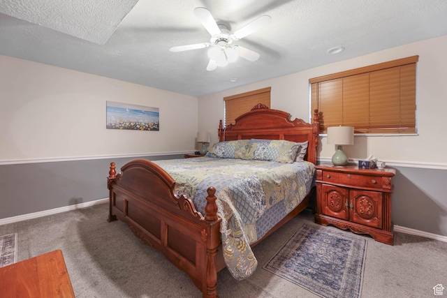 bedroom featuring carpet floors, baseboards, ceiling fan, and a textured ceiling