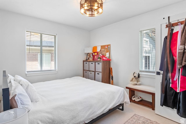 bedroom featuring light carpet