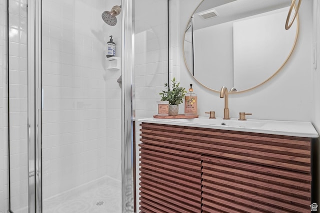 full bath with a shower stall and vanity