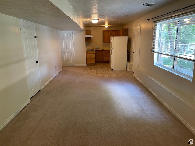 595 N 1200th St E, Lehi, UT 84043 - unfurnished living room with light colored carpet, baseboards, a textured ceiling, and a sink