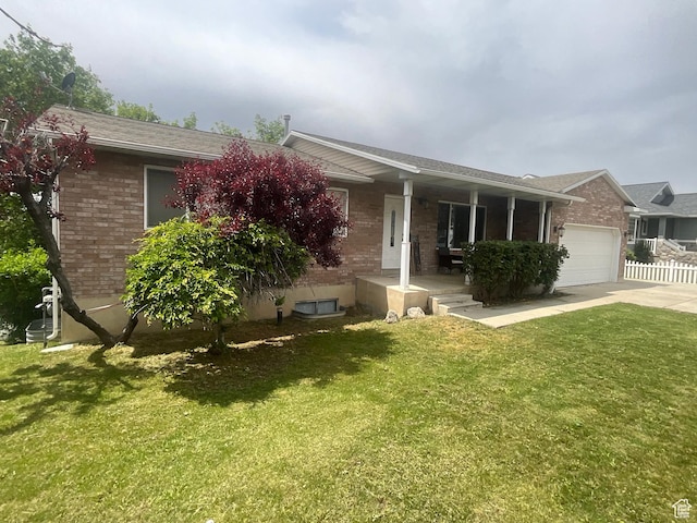 595 N 1200th St E, Lehi, UT 84043 - single story home with covered porch, brick siding, concrete driveway, and an attached garage