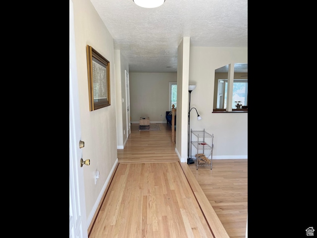 595 N 1200th St E, Lehi, UT 84043 - hall with a textured ceiling, light wood finished floors, baseboards, and arched walkways
