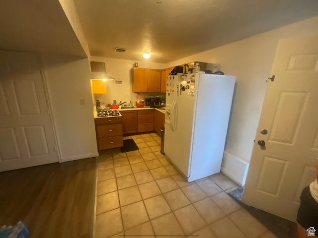 595 N 1200th St E, Lehi, UT 84043 - kitchen with white refrigerator with ice dispenser, light tile patterned floors, light countertops, and a sink