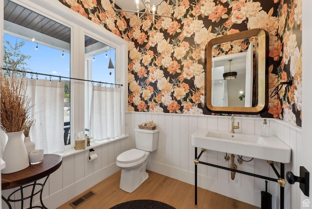 1677 Lambert Ln, Kamas, UT 84036 - bathroom with wallpapered walls, wood finished floors, a wainscoted wall, toilet, and a sink