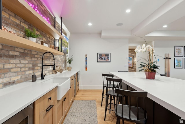 1677 Lambert Ln, Kamas, UT 84036 - kitchen with open shelves, a sink, a breakfast bar area, baseboards, and recessed lighting
