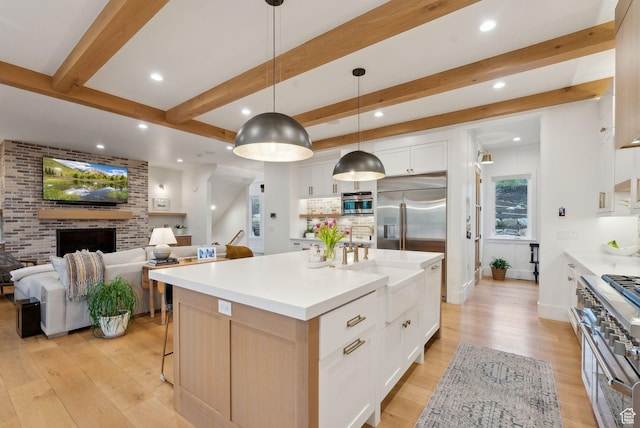 1677 Lambert Ln, Kamas, UT 84036 - kitchen with high quality appliances, recessed lighting, light wood-style floors, beam ceiling, and white cabinetry