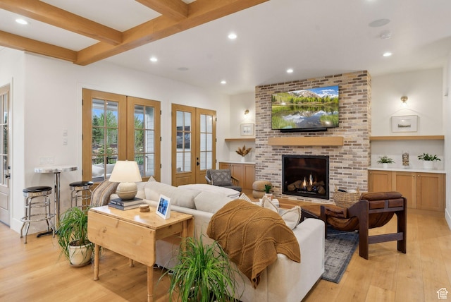 1677 Lambert Ln, Kamas, UT 84036 - living area featuring french doors, light wood finished floors, recessed lighting, a brick fireplace, and beam ceiling