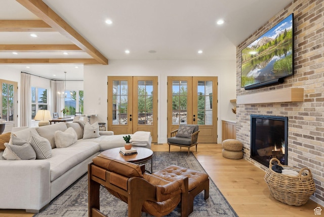 1677 Lambert Ln, Kamas, UT 84036 - living room with wood finished floors, recessed lighting, a brick fireplace, healthy amount of natural light, and french doors