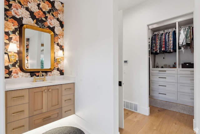 1677 Lambert Ln, Kamas, UT 84036 - bathroom with wood finished floors, vanity, a walk in closet, and baseboards