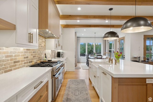 1677 Lambert Ln, Kamas, UT 84036 - kitchen with stainless steel range, a sink, healthy amount of natural light, beam ceiling, and light countertops