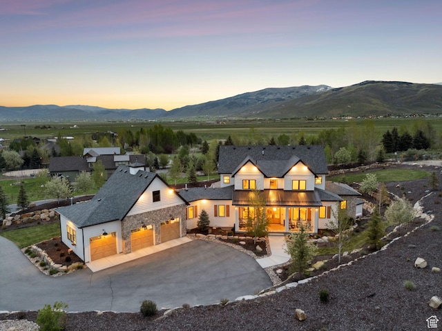 1677 Lambert Ln, Kamas, UT 84036 - rear view of property with a mountain view, driveway, a porch, and stone siding