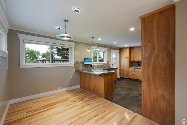 2925 N 220 E, Provo, UT 84604 - kitchen with a peninsula, baseboards, tasteful backsplash, brown cabinetry, and recessed lighting