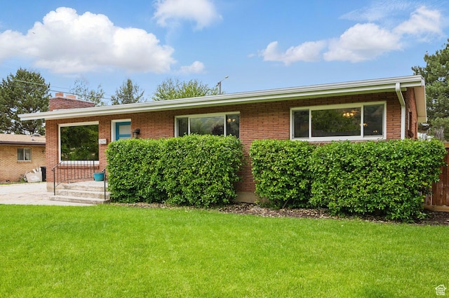 2925 N 220 E, Provo, UT 84604 - view of front of property featuring a chimney, a front lawn, and brick siding