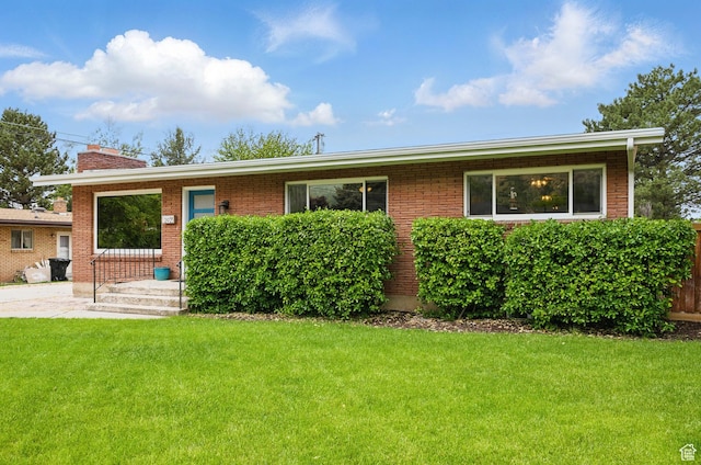 2925 N 220 E, Provo, UT 84604 - view of front of home featuring a front lawn, a chimney, and brick siding