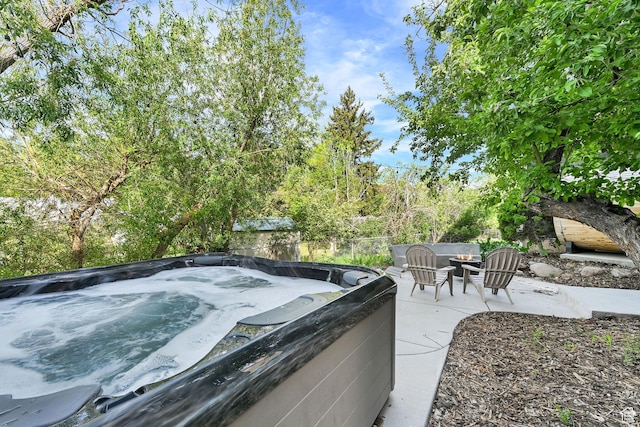3553 N Willow Creek Ln E, Eden, UT 84310 - view of patio featuring a hot tub and an outdoor fire pit