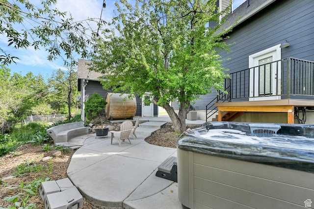 3553 N Willow Creek Ln E, Eden, UT 84310 - view of patio / terrace with a hot tub and a fire pit