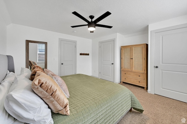 3553 N Willow Creek Ln E, Eden, UT 84310 - bedroom with light carpet, a ceiling fan, and a textured ceiling