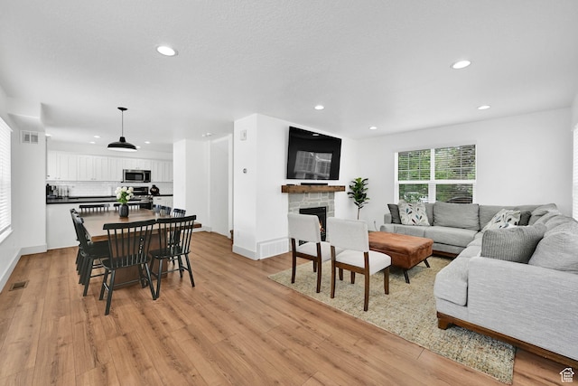 3553 N Willow Creek Ln E, Eden, UT 84310 - dining room with recessed lighting, light wood-style floors, a stone fireplace, and baseboards