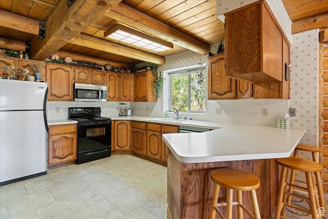5375 N 3325 E, Eden, UT 84310 - kitchen with freestanding refrigerator, black electric range oven, stainless steel microwave, wood ceiling, and wallpapered walls