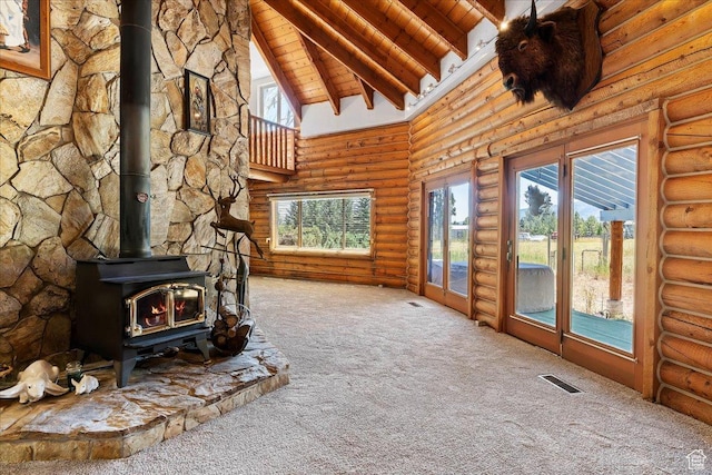 5375 N 3325 E, Eden, UT 84310 - unfurnished living room featuring carpet floors, wooden ceiling, a wood stove, beam ceiling, and healthy amount of natural light