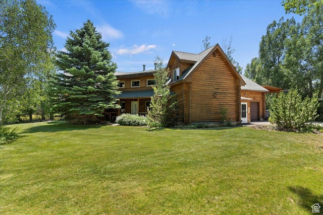 5375 N 3325 E, Eden, UT 84310 - back of property featuring a garage, log exterior, and a lawn