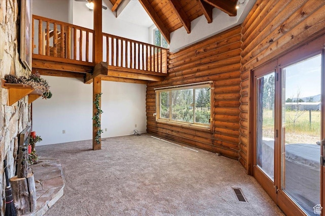 5375 N 3325 E, Eden, UT 84310 - unfurnished living room with rustic walls, plenty of natural light, carpet, high vaulted ceiling, and beamed ceiling