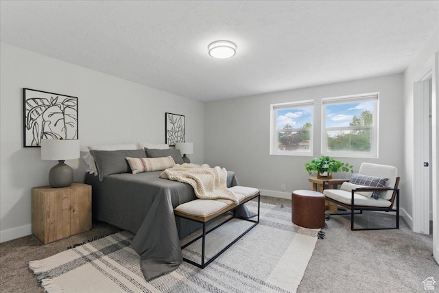 carpeted bedroom featuring baseboards