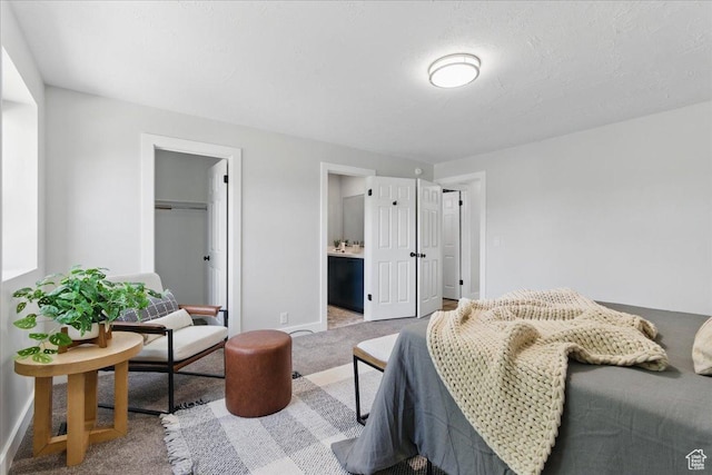 carpeted bedroom with baseboards and a closet
