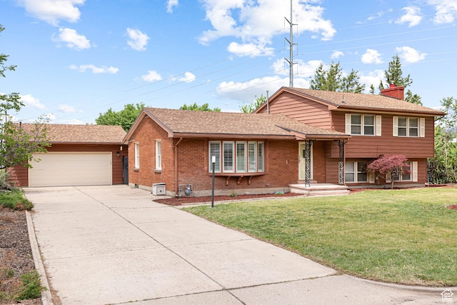 4115 Edgehill Dr, Ogden, UT 84403 - split level home with concrete driveway, a chimney, a garage, brick siding, and a front yard