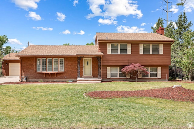 4115 Edgehill Dr, Ogden, UT 84403 - split level home featuring a chimney, an attached garage, a front lawn, brick siding, and driveway
