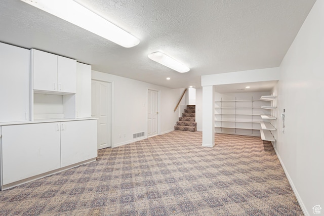4115 Edgehill Dr, Ogden, UT 84403 - finished basement featuring a textured ceiling, carpet flooring, baseboards, stairs, and recessed lighting